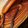 Half Breed Vaquero Wade Saddle by Keith Valley   Specs: Wade tree by Rick Reed 15 & 1/2 inch seat, Gullet - 7 & 1/2H X 6 & 1/4W X 4, 93 Degree Bars, Horn - 3 & 5/8ths high X 4 & 1/2 Guatelajara, Cantle - 4&1/2 inches high X 12&1/2 inches wide, Cheyenne Roll - 1 & 3/4 inches, 7/8ths flat plate riggin.  Sporting Keith's Vaquero Border with Sheridan Floral tooling within, Stainless Steel Hardware - by Harwood, 4 inch Monel Stirrups, Santa Barbara twisted for easy handling, Vaquero outside stirrup leathers, 100% handmade Mohair Roper Cinch, Hand cut 7 foot latigos for both sides.  Made for a special order - **SOLD** but we take orders.